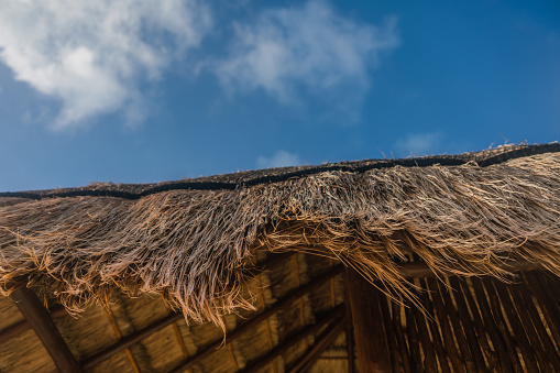 Close up of Corner of a Straw Hut with Sky in the Background