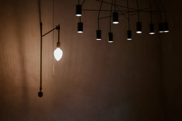 istock lamp turned on in a dark room 1352081997