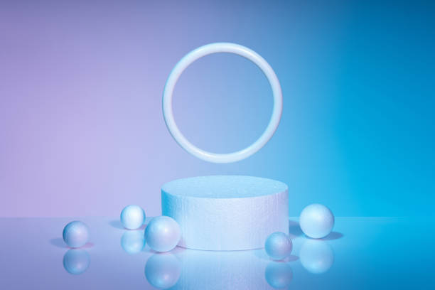istock Modern cylindrical podium and white balls on blue-pink background 1352082237