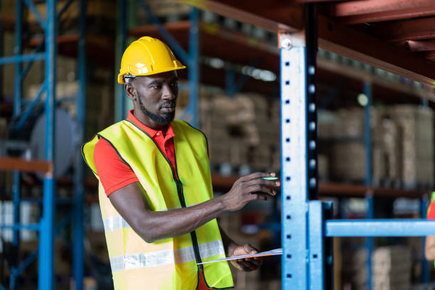 istock African American male worker using clipboard working with products or parcel goods on shelf pallet in industrial storage warehouse 1352083193