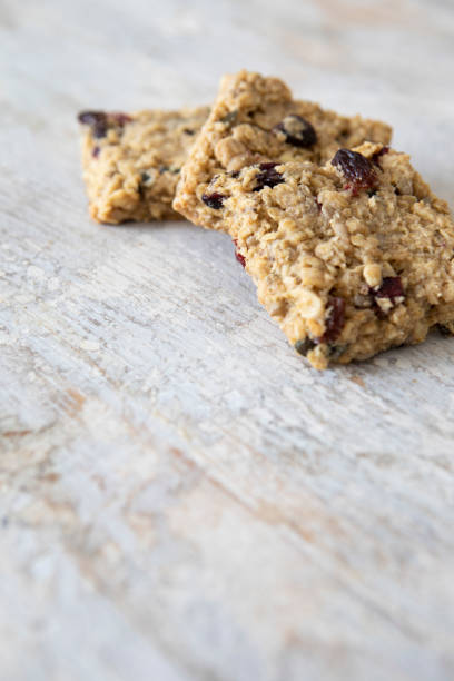 istock Close-up of three granola cookies on a rustic wooden table, with copy space 1352083877