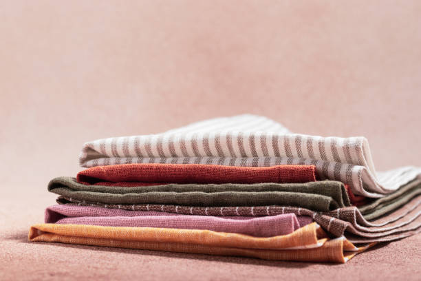 istock Stack of colored serving napkins on beige background 1352083952