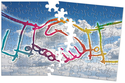 Handshake against a cloudscape background - concept image in jigsaw puzzle shape