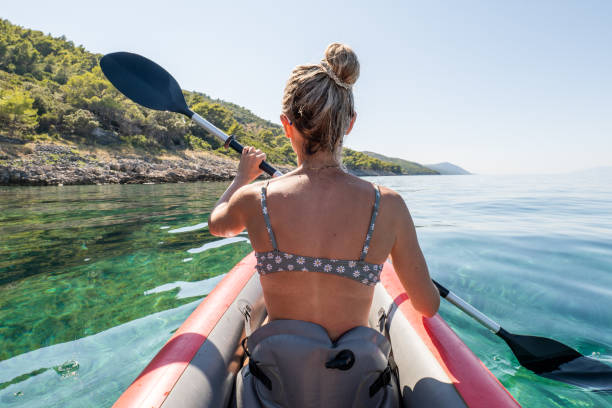 istock Rear view of woman on canoe 1352087493