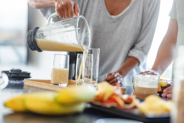 istock Hispanic mother and son making a smoothie with a blender 1352087532
