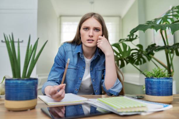 istock Positive smiling female university student talking looking at webcam, at home. 1352087984