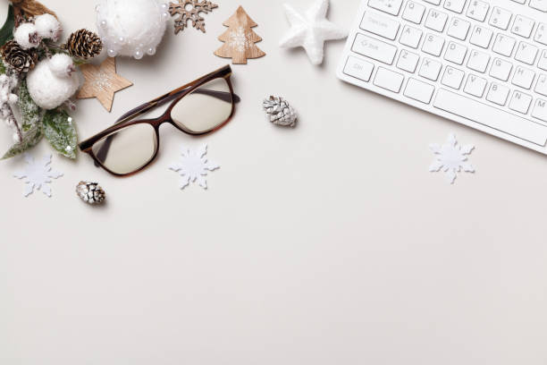 istock Desk table work. New Years Christmas winter composition. Keyboard glasses ornament on a gray table. Flat lay top view copy space 1352088505