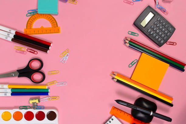 istock School supplies on a pink Board. Back to school 1352089623