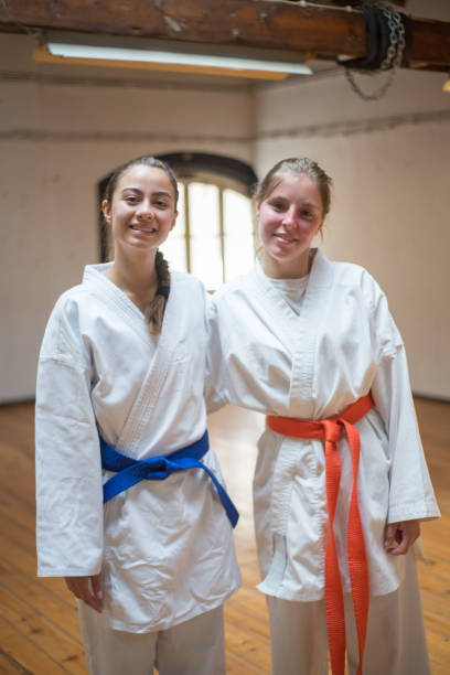 istock Happy female karate girls hugging in studio after class 1352092487