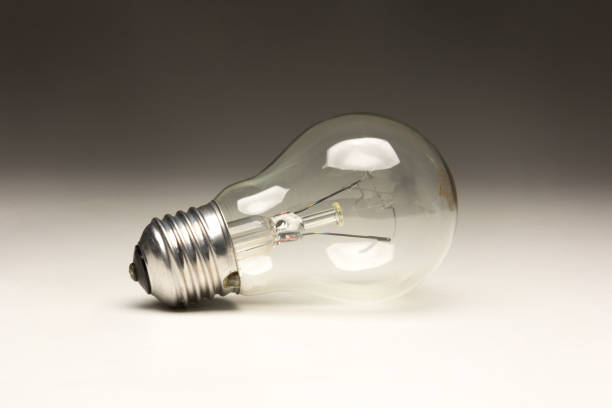 istock Clear glass incandescent filament bulb, analog technology 1352092653