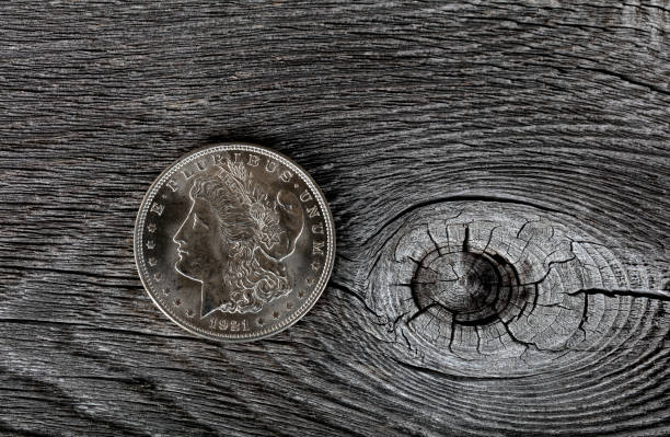 istock 1921 vintage Morgan silver dollar on aged wood background 1352092917