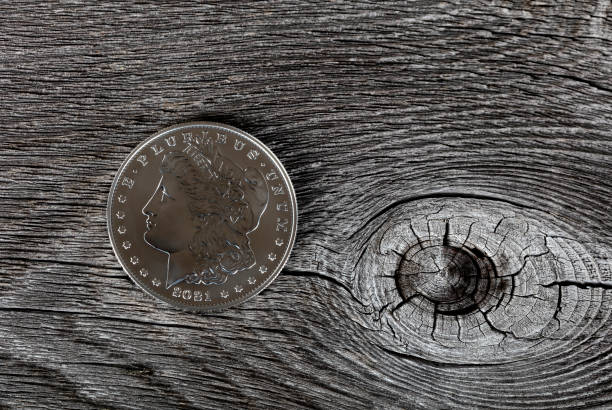 istock 2021 Morgan silver dollar for hundredth anniversary on vintage wood background 1352092929