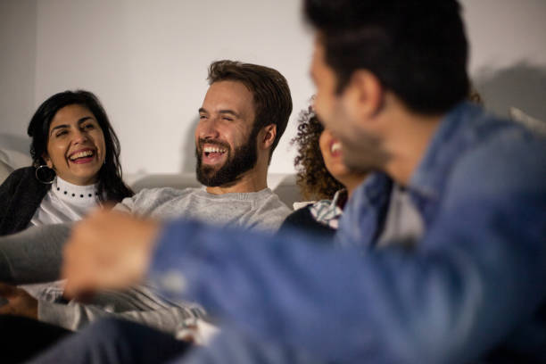 istock Group of friends laughing while watching a movie 1352093091