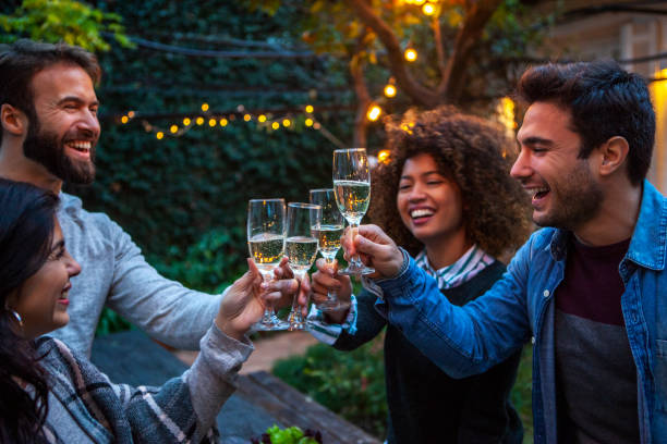 istock Multiracial group of friends celebrating and laughing while toasting 1352093245