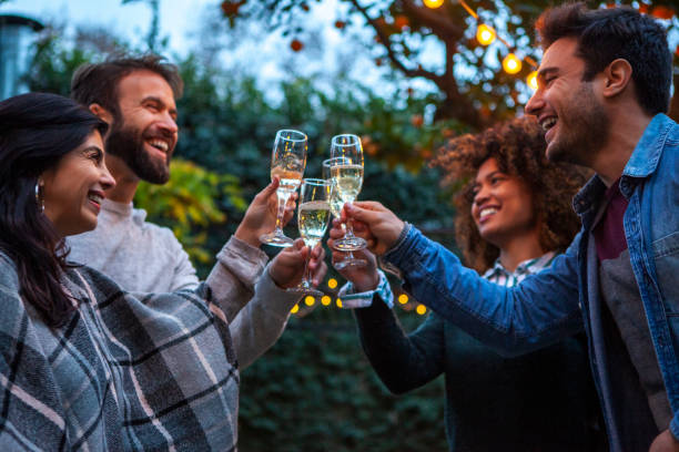 istock Multiracial group of friends celebrating and laughing while toasting 1352093247
