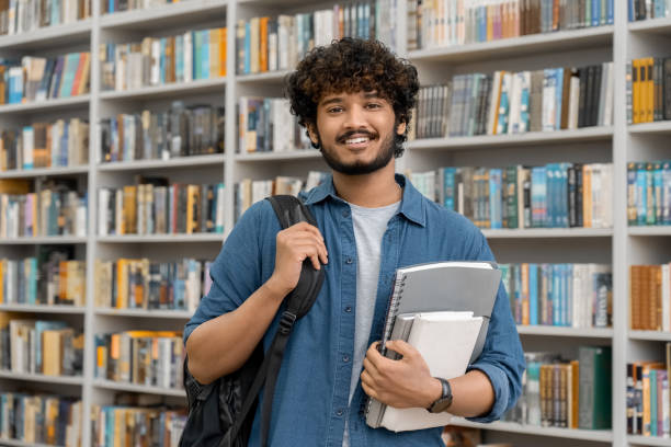istock Cheerful male international student at university library or book store 1352093253
