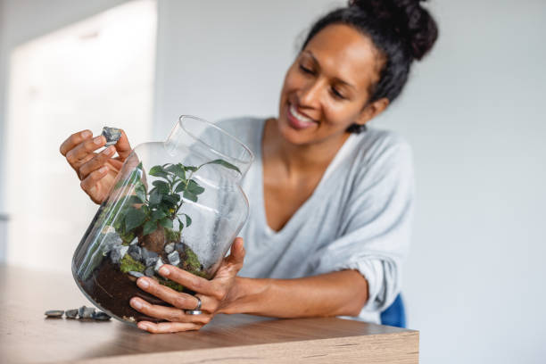 istock Cheerful hispanic woman making a self sustaining eco flower system 1352093334