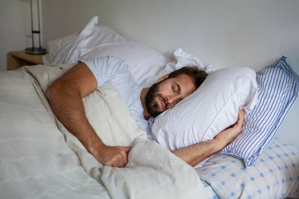 istock Adult man sleeping in bed during day 1352093436
