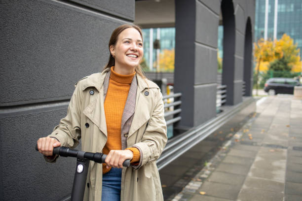 Modern Caucasian woman on electric scooter stock photo