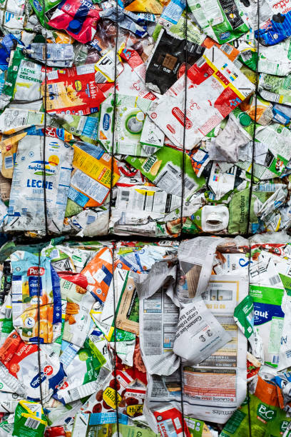 Compacted milk cartons in containers stacked at a recycling center stock photo