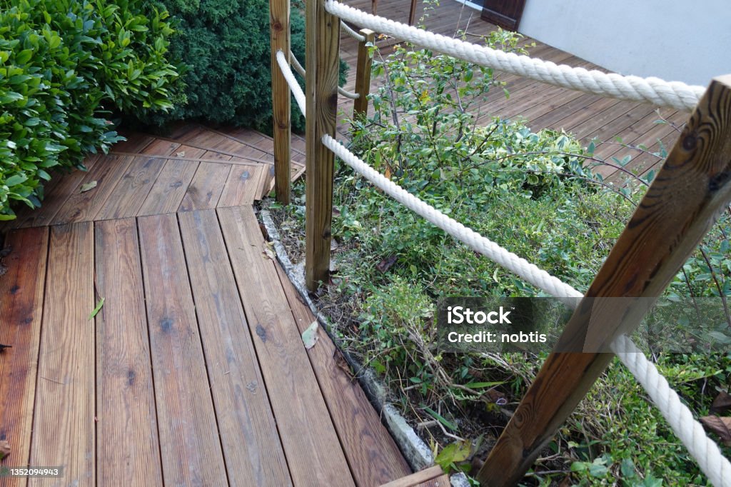 Garden terrace and wooden staircase   Rope stair railing  Garden of the house Railing Stock Photo