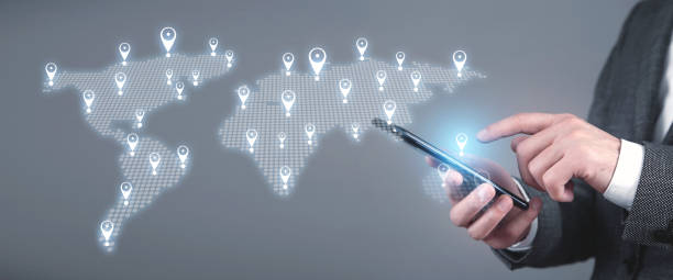 istock Male hands holding smartphone. World map with a GPS navigation 1352095982