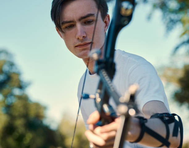 istock Shot of a young man out practising on the archery range 1352096222