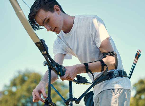 istock Shot of a young man out practising on the archery range 1352096251