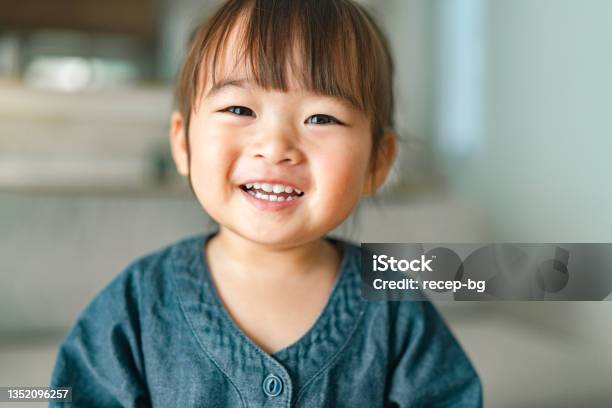 Portrait Of Small Girl In Living Room At Home Stock Photo - Download Image Now - Child, Smiling, Baby - Human Age