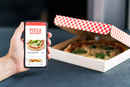Pizza delivery and food app in phone. Online order restaurant take away. Lunch menu in cellphone screen with takeout box. Hungry customer using website with review and rating. Takeaway service.