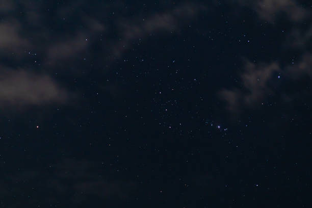 Starry Night Sky over Water with Orion Constellation in the Sky