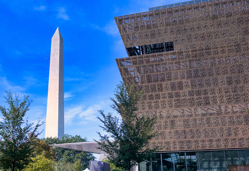 Washington, D.C. - October 14th, 2021: The Smithsonian's National Museum of African American History and Culture on the National Mall with the Washington Monument.