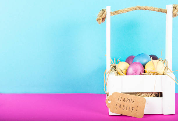 istock Colorful background with Easter eggs on pink and blue background. Happy Easter concept. Can be used as poster, background, holiday card. Flat lay, top view, copy space. Studio Photo 1352100495