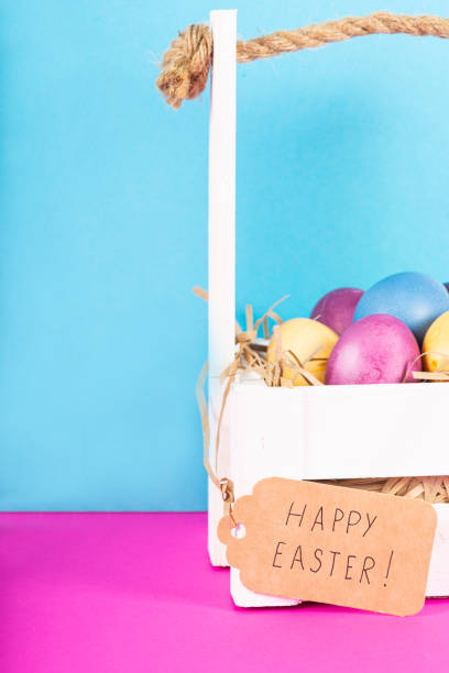 istock Colorful background with Easter eggs on pink and blue background. Happy Easter concept. Can be used as poster, background, holiday card. Flat lay, top view, copy space. Studio Photo 1352100501