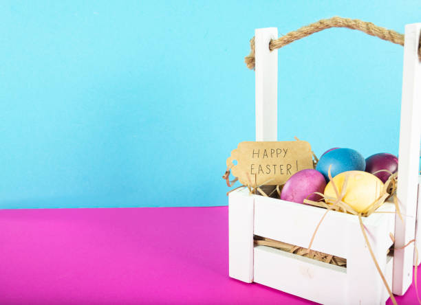 istock Colorful background with Easter eggs on pink and blue background. Happy Easter concept. Can be used as poster, background, holiday card. Flat lay, top view, copy space. Studio Photo 1352100510