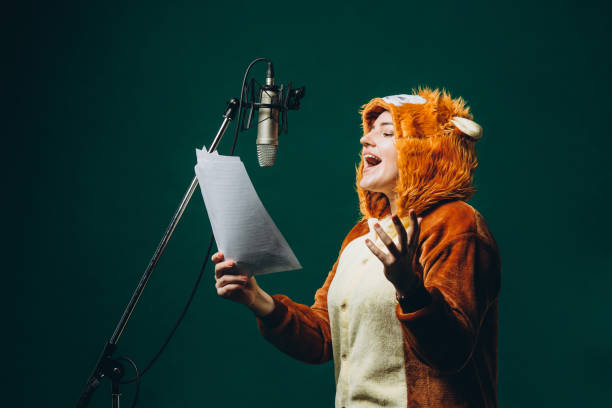 woman prepares herself and a material before voice recording. soundproof room for professional recording vocal. voice artist works with material before dubbing or voice over process - voice over imagens e fotografias de stock