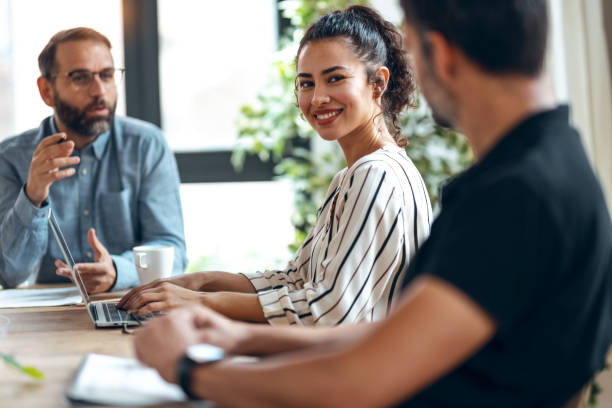 istock Casual multiage business people working with laptops while talking of they new project together in the office. 1352101517