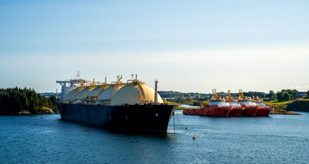 Fjord landscape with LNG tanker and tug ships in Norway Ships waiting in a fjord in Norway liquefied natural gas stock pictures, royalty-free photos & images