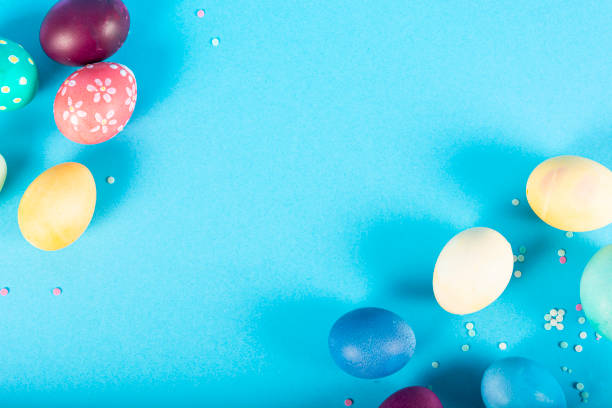 istock Colorful background with Easter eggs on blue background. Happy Easter concept. Can be used as poster, background, holiday card. Flat lay, top view, copy space. Studio Photo 1352102352