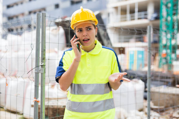 istock Woman architect talking by phone at building site 1352102533