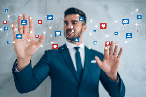 Shot of a handsome young businessman receives notifications and touching the graphics with hands. Social media and digital online concept. Social media and people network technology concept.