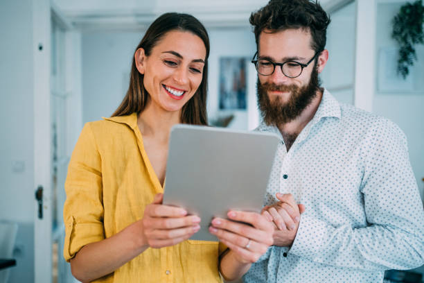 istock Confident business partners working on digital tablet in office. 1352105602