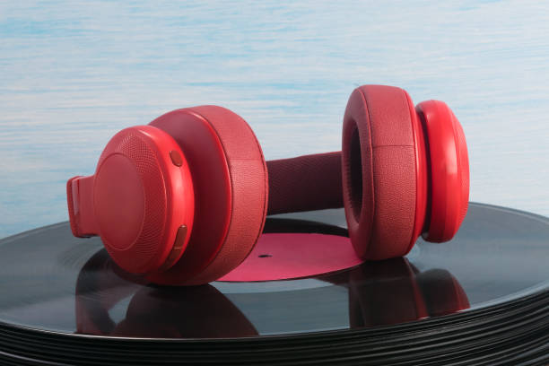 istock red headphones lie on an old vinyl record 1352106389