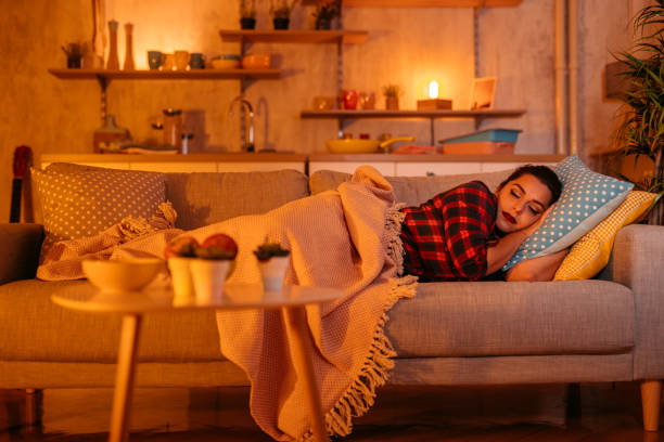 istock Beautiful young woman sleeping on sofa 1352107864