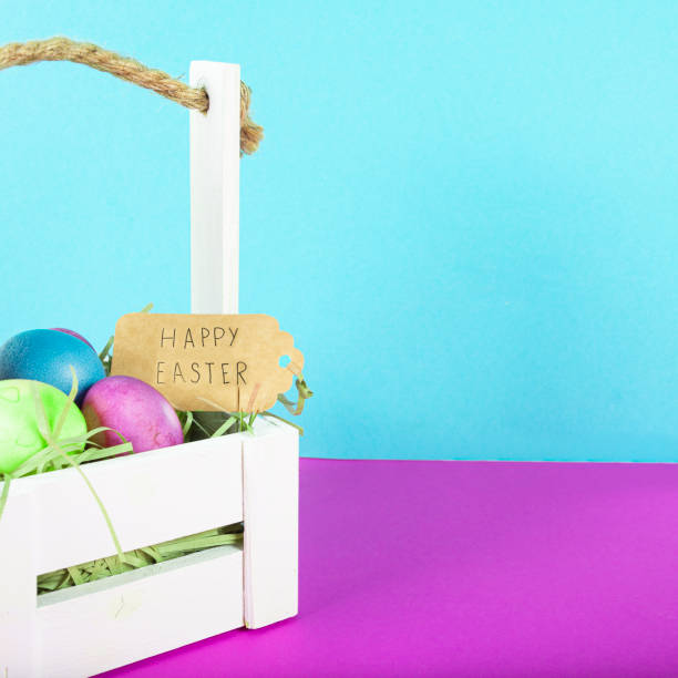istock Colorful background with Easter eggs on purple and blue background. Happy Easter concept. Can be used as poster, background, holiday card. Flat lay, top view, copy space. Studio Photo 1352108639