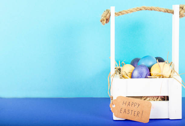 istock Colorful background with Easter eggs on blue background. Happy Easter concept. Can be used as poster, background, holiday card. Flat lay, top view, copy space. Studio Photo 1352108645