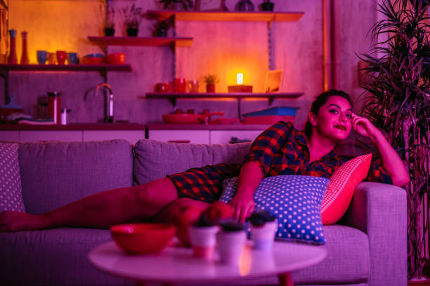 istock Beautiful young woman lying on sofa 1352108769