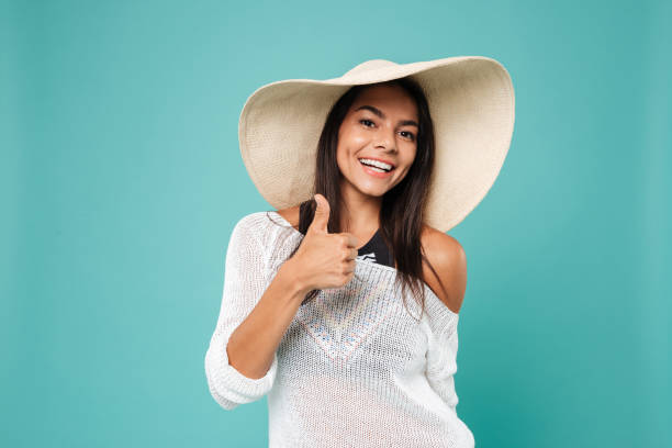 istock Smiling young lady wearing hat make thumbs up gesture. 1352108770