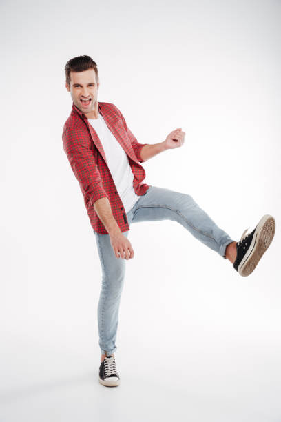 istock Vertical image of man playing on imaginary guitar 1352110210
