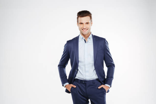 istock Smiling business man with arms in pockets 1352110758